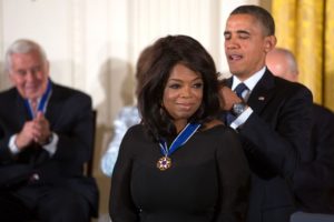 Oprah receiving a peace medal from President Obama